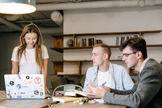 Group of young professionals engaged in teamwork and brainstorming at a modern office.